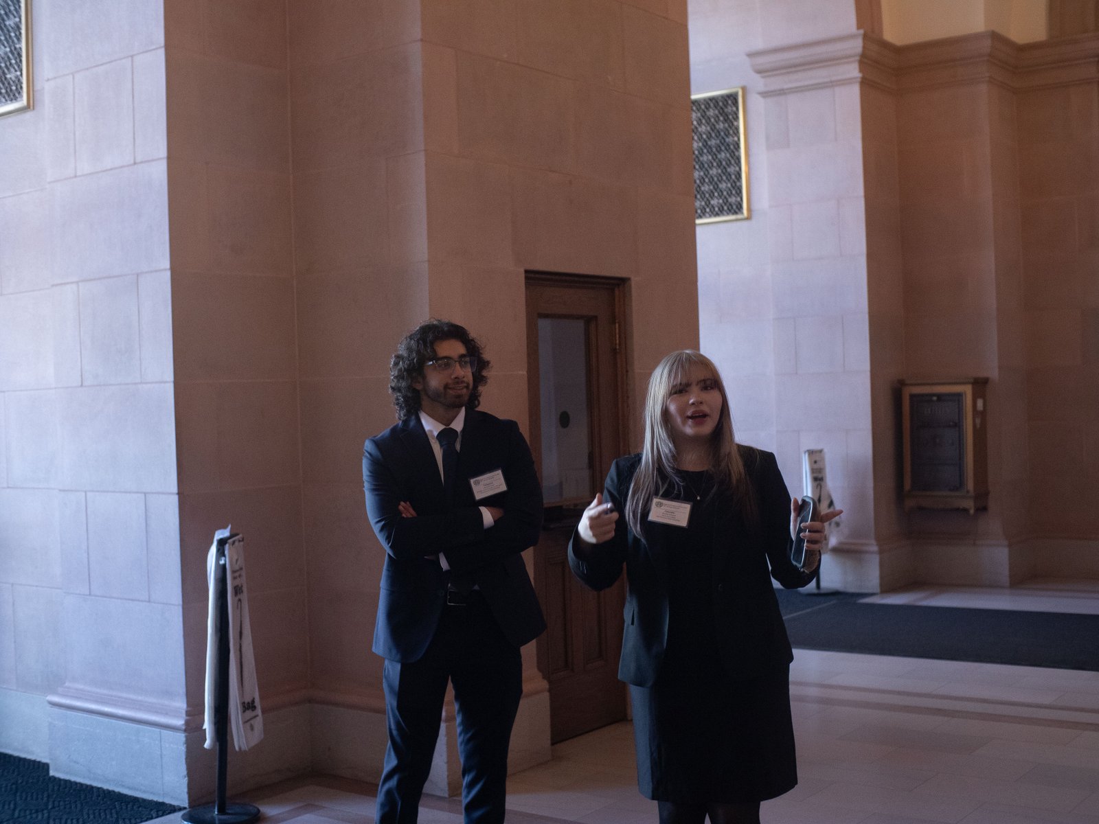 Hamed Emari and a delegate talking in the conference hall