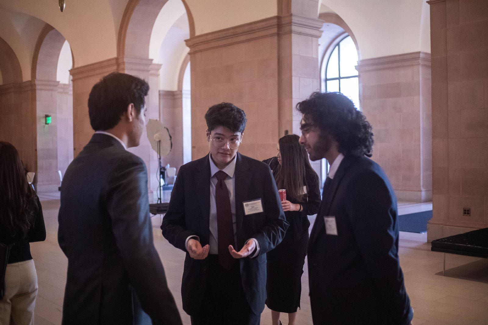 Three delegates in discussion during an unmoderated caucus
